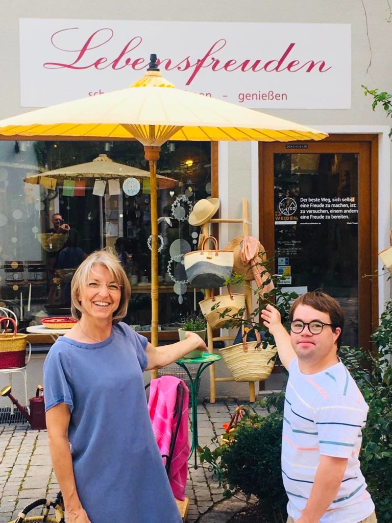 store owner Sieglinde Scharnagl and Ludwig in front of Lebensfreuden weiden shop